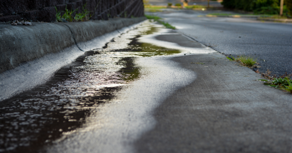stormwater running into street needing stormwater maintenance
