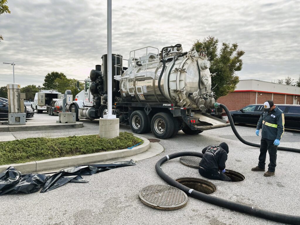 Vacuum truck service being performed